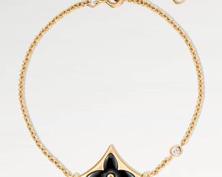 Authentic Louis Vuitton Color Blossom BB Star Bracelet featuring an 18-karat yellow gold chain set with a hand-polished black onyx Monogram flower and a sparkling accent diamond. Total length measures 7". Original box is not available. Discount will be offered if purchased with matching ring