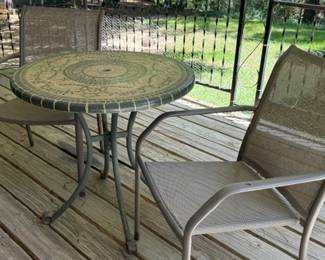 Patio table with two metal chairs