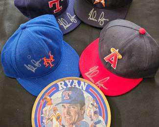 Numerous autographed baseball hats by HOFamer Nolan Ryan.