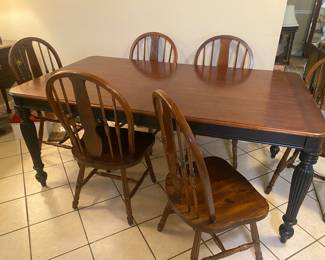 Casual dining table has two leaves. Black distressed legs.  