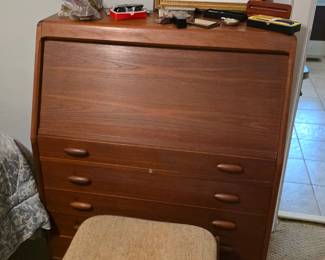 Dyrlund teak secretary desk features a tambour door that rolls up to reveal a work surface.