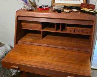 Dyrlund teak secretary desk features a tambour door that rolls up to reveal a work surface.
