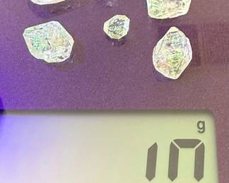 Petroleum Quartz, also known as golden enhydros, which are quartz crystals containing trapped pockets of fluorescent oil.