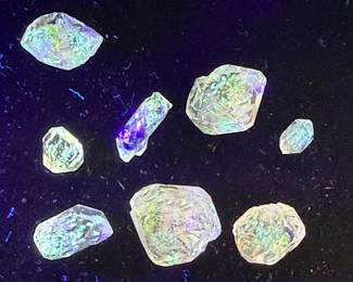 Petroleum Quartz, also known as golden enhydros, which are quartz crystals containing trapped pockets of fluorescent oil.