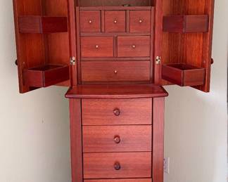 Rotating jewelry cabinet with full length mirror.