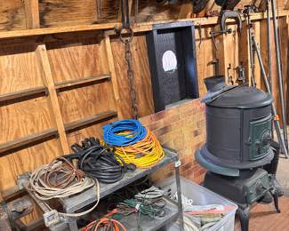 Extension cords, utility cart, woodstove, sea clamps, pipe, wrenches, ropes
