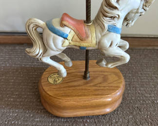 Lot 40: Mini musical carousel horse on wooden base
