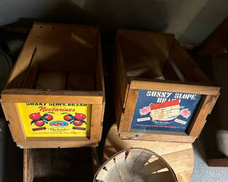 Lot 222: Vintage wooden fruit crates with advertising panels and a round metal basket