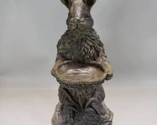 232 Lot 53 Composite sculpture of rabbit holding basket