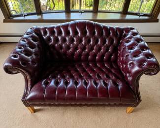 an Burgundy Tufted ChesterfieldStyle Leather Loveseat with Nailhead Trim