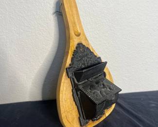 an Vintage Cast Iron and Wood WallMounted Match Holder