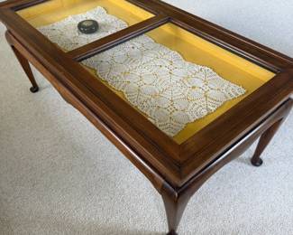 Vintage-style coffee table with glass display top and Queen Anne legs