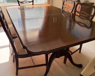 Vintage-style mahogany dining room table and chairs
