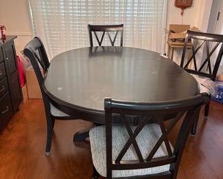 Black kitchen table with 4 chairs. Extension comes out