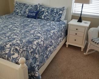 Queen bed; nightstand; table lamp