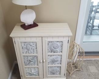 Cupboard; scallop shell table lamp; fish wine bottle holder