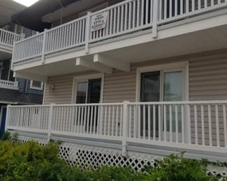 Vinyl railing; navy awning; sliding glass doors