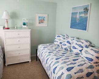 Twin bed; 5-drawer dresser; table lamp