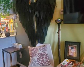 Angel wings, tulip chair, pillows, CR magazines, end table
