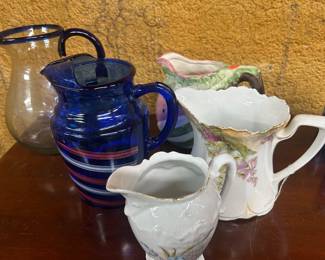 Collection of glass and porcelain pitchers