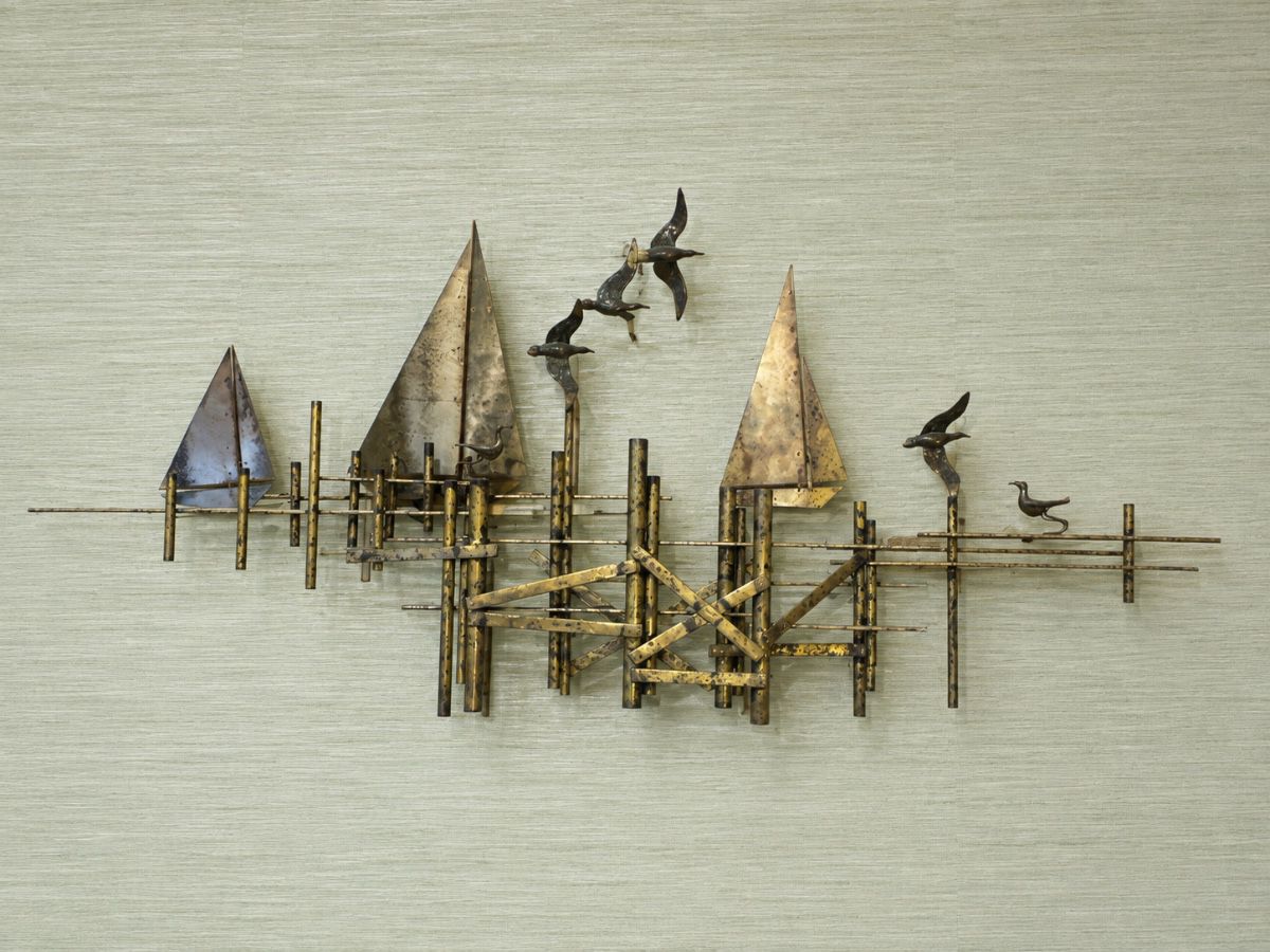 Mid-Century Modern Brutalist wall sculpture by Curtis Jeré depicts a harbor scene with gilded brass sailboats, a dimensional pier structure, and soaring seagulls
