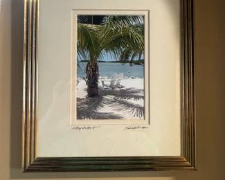 coastal art features a tropical beach scene with white Adirondack chairs under a palm tree, titled "Key West" and signed "Sullivan