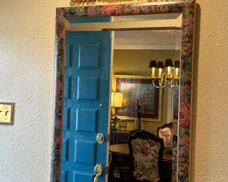 vintage floral-patterned wall mirror features a classic rectangular wooden frame with a decorative gilt crest accent on top.