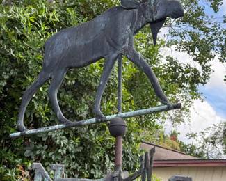 Large moose weather vane on pole
