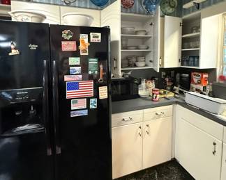 Side by side refrigerator, more colanders and dishes 