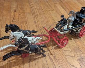 Vintage toy horse drawn firetruck with two riders cast iron. Likely reproduction of earlier antique