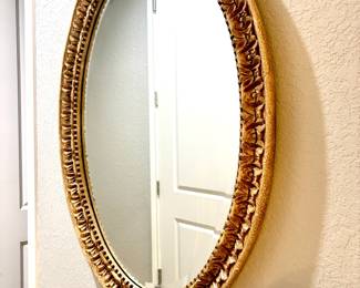 Oval gold tone mirror