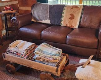 Primitive wagon and woven rugs