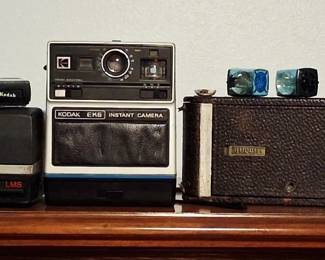 Vintage cameras. Antique Kodak folding autographic Brownie Camera & Poloroid instant cameras
