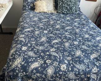 full size bed frame and mattress with navy blue paisley bedding