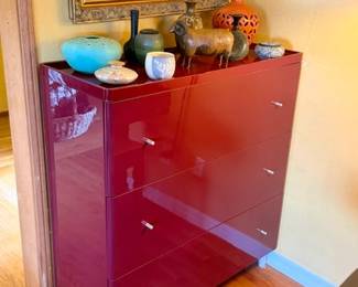 Striking high-gloss burgundy dresser