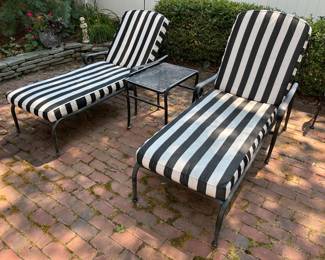Two Woodard chaise lounge chairs and side table.