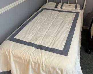 Twin bed with metal frame, mattress and box.