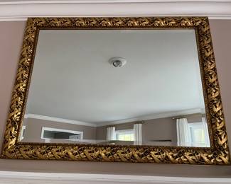 Ornate gold-framed mirror.