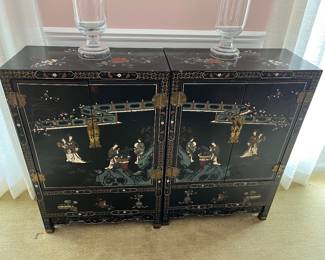 Pair of vintage Chinese Chinoiserie cabinets with a black lacquer finish.