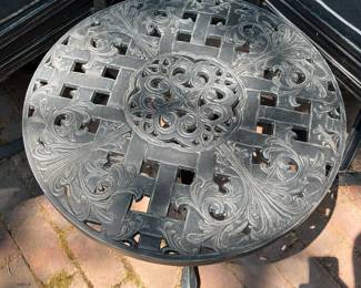 One of two matching cast aluminum side tables.