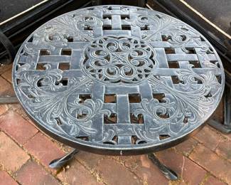 One of two matching cast aluminum side tables.