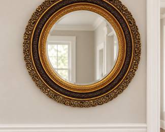 Round ornately framed mirror