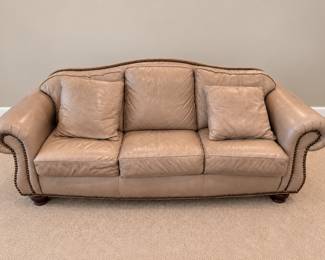 One of two Thomasville  leather sofaswith nail head trim