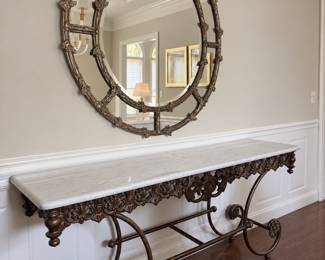 Iron base, marble, top console table, and large round mirror with beveled glass