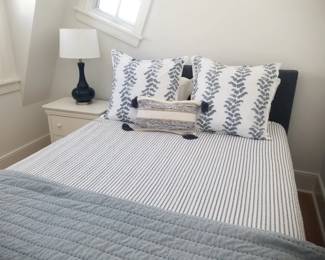 Queen bed; nightstand; table lamp