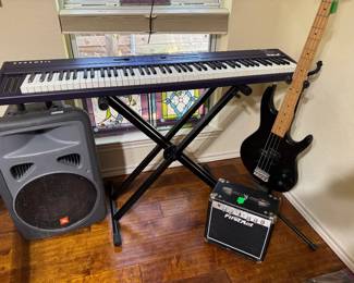JBL Eon Power speaker, Kurzweil keyboard SP88, Ibanez 4 string electric guitar TRB50, FirstAct Amplifier