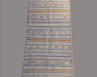 Neutral striped rug with subtle multicolor woven detailing