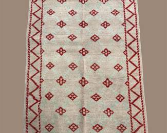 Ivory geometric rug with repeating burgundy diamond motifs