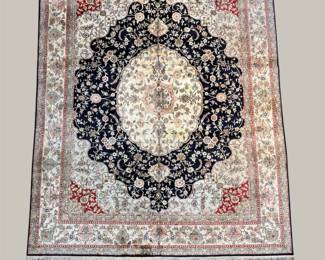 Ivory traditional rug with ornate dark medallion and floral detailing