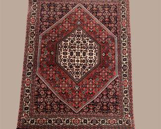 Burgundy traditional rug with bold central diamond medallion